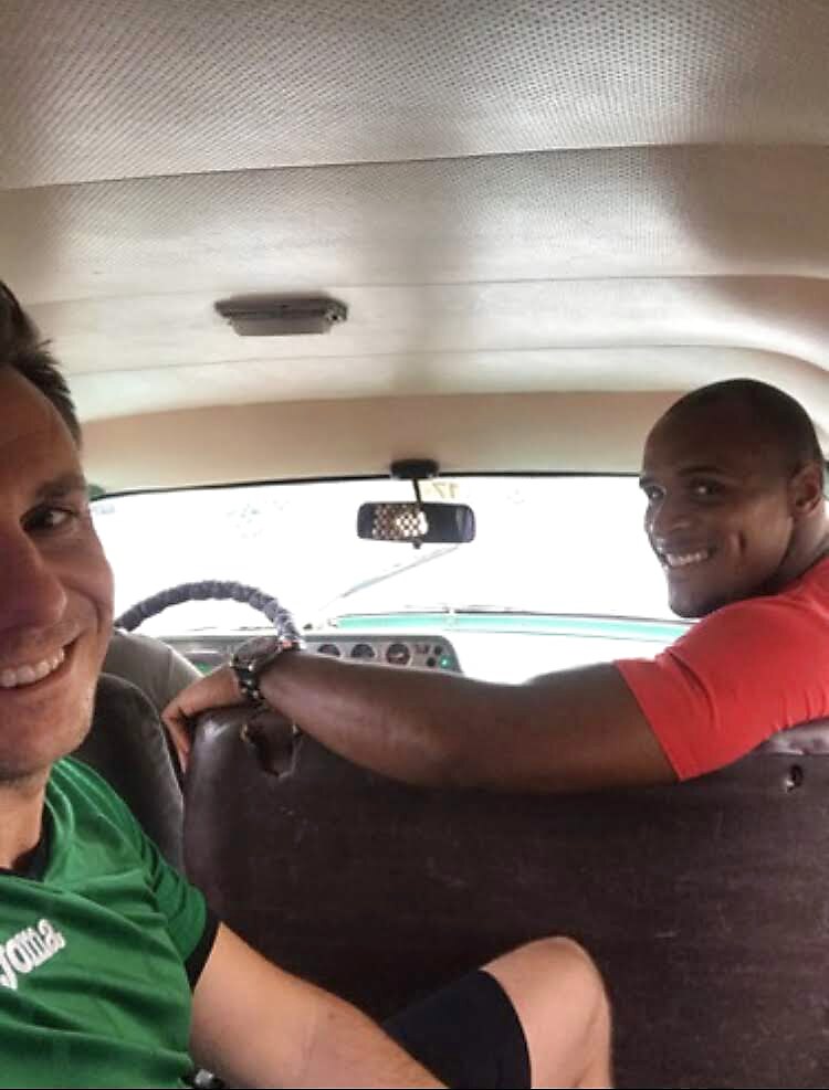 Randy and a guest riding to Alamar in a classic Cuban car
